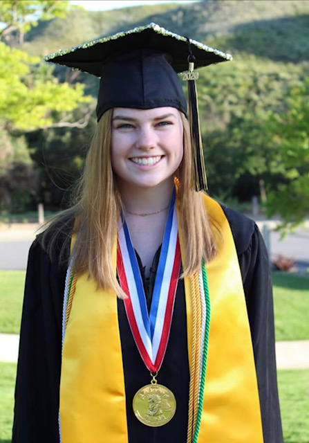Graduated student wearing graduation robe with ASLHS stole and honor medal.